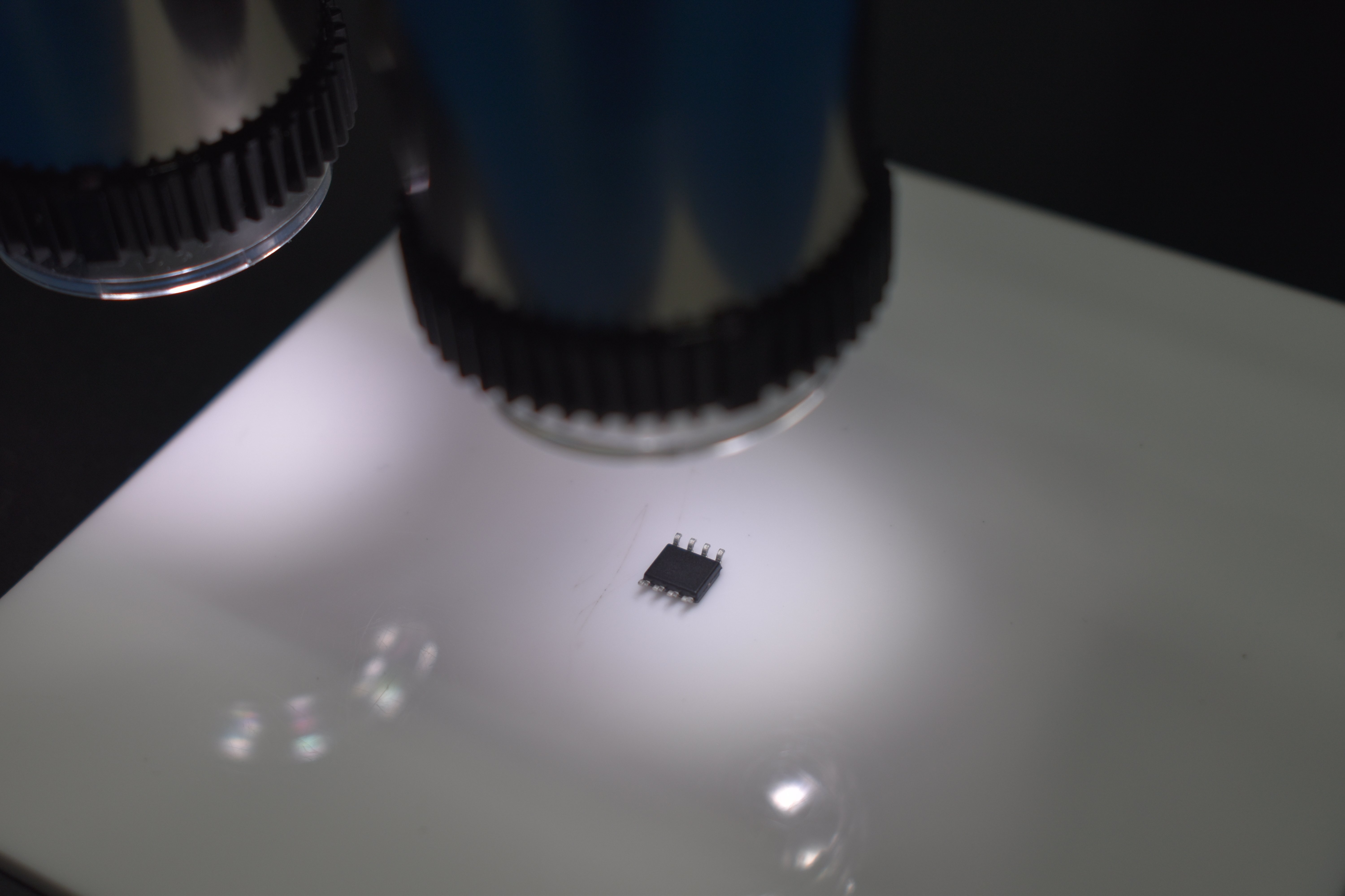 The underside of an electronic component underneath a microscope for inspection.