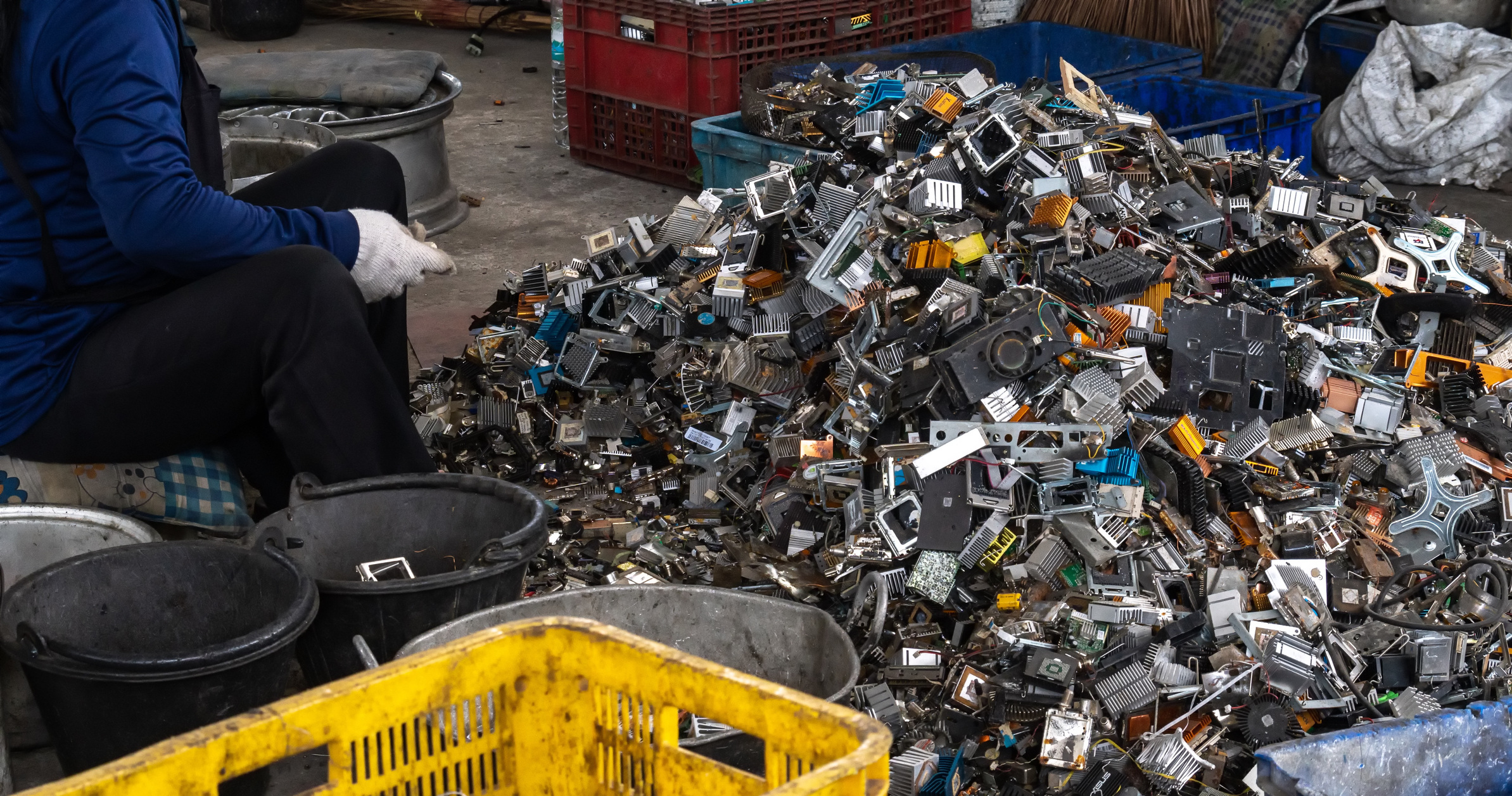 Pile of electronic waste being sorted by hand.