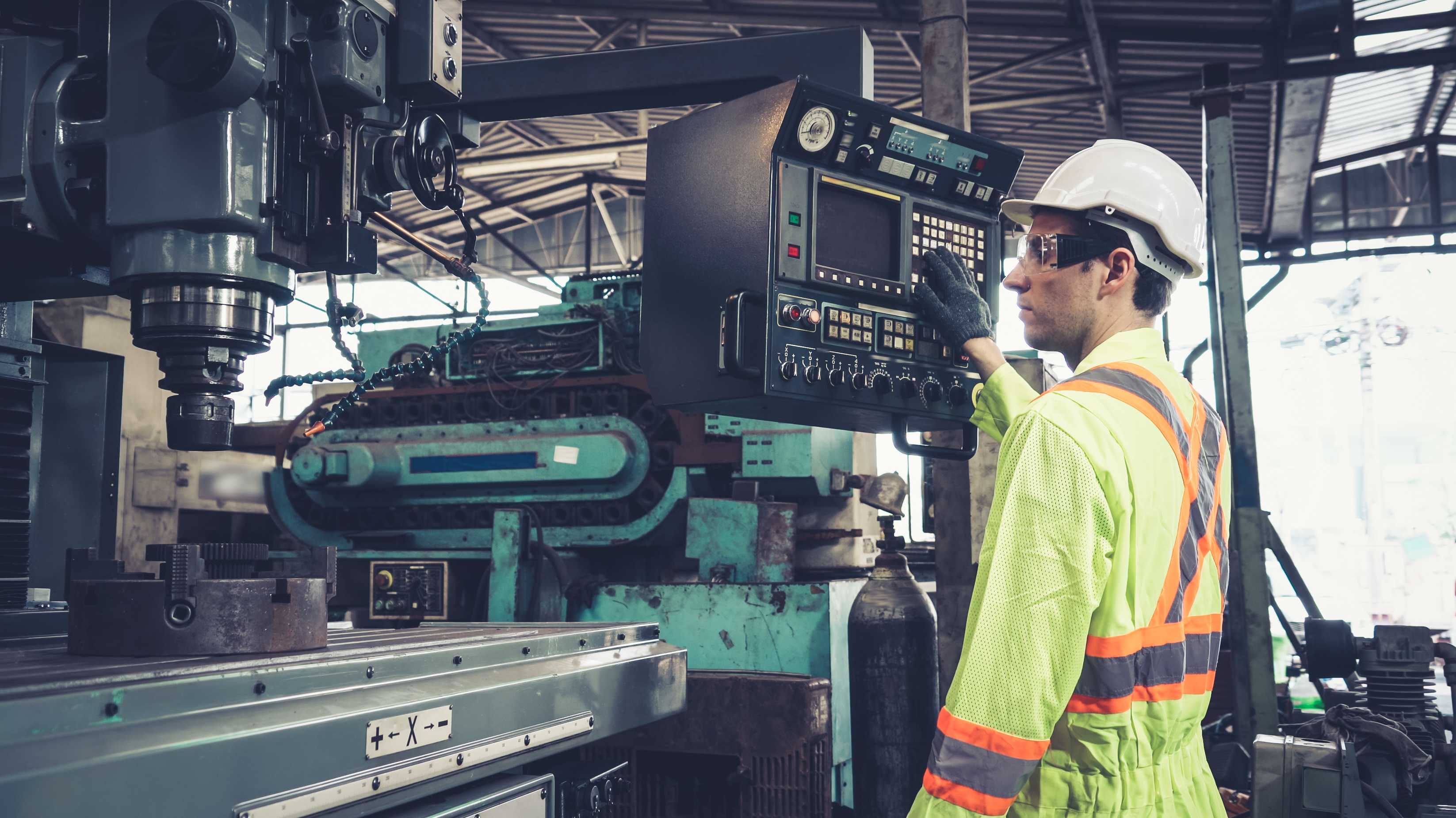 Old industrial machinery in use by a worker.