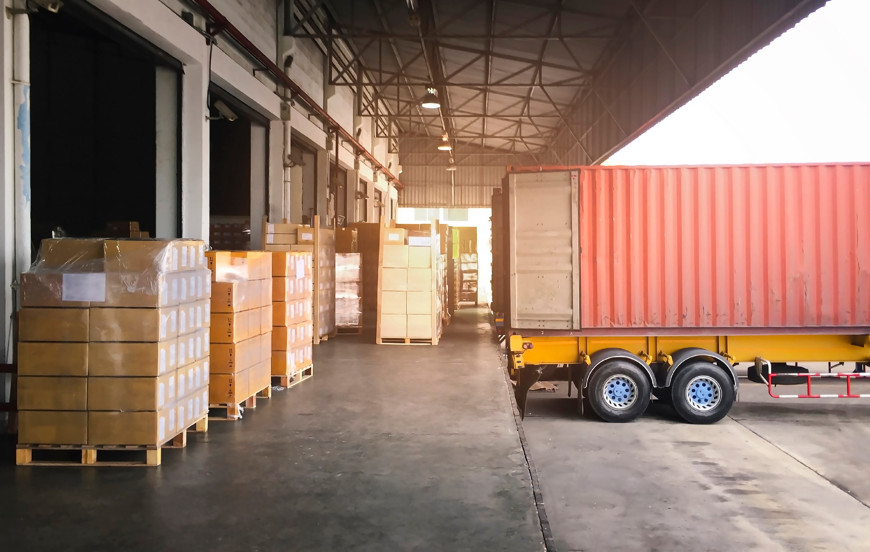 Boxes being loaded into the back of a truck.