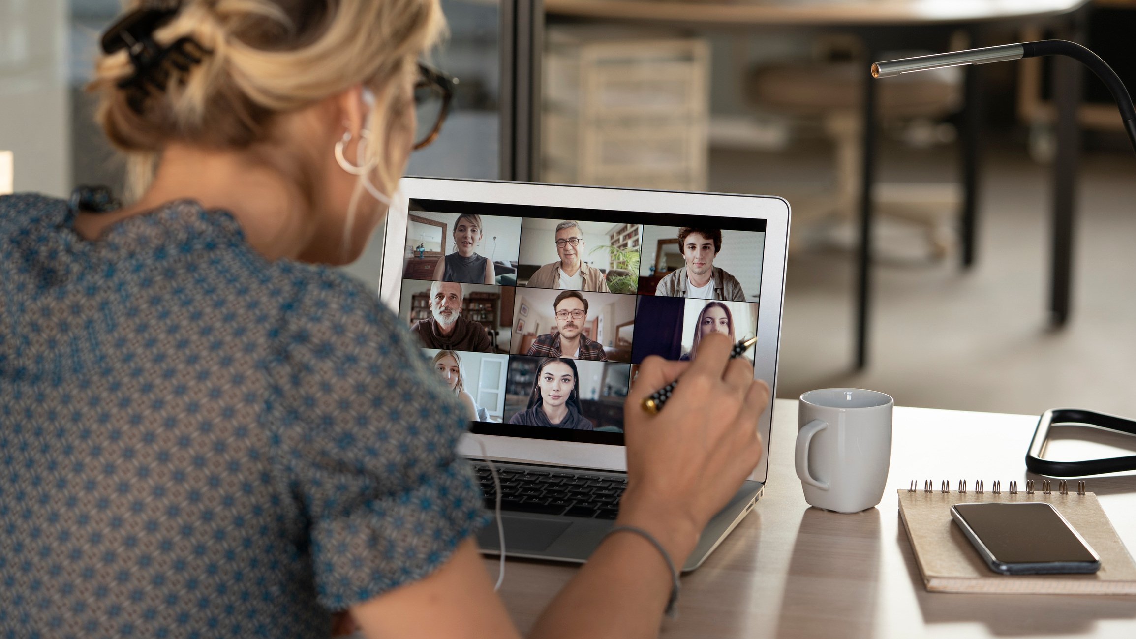 Lady on a video call with work colleagues pitching an idea.