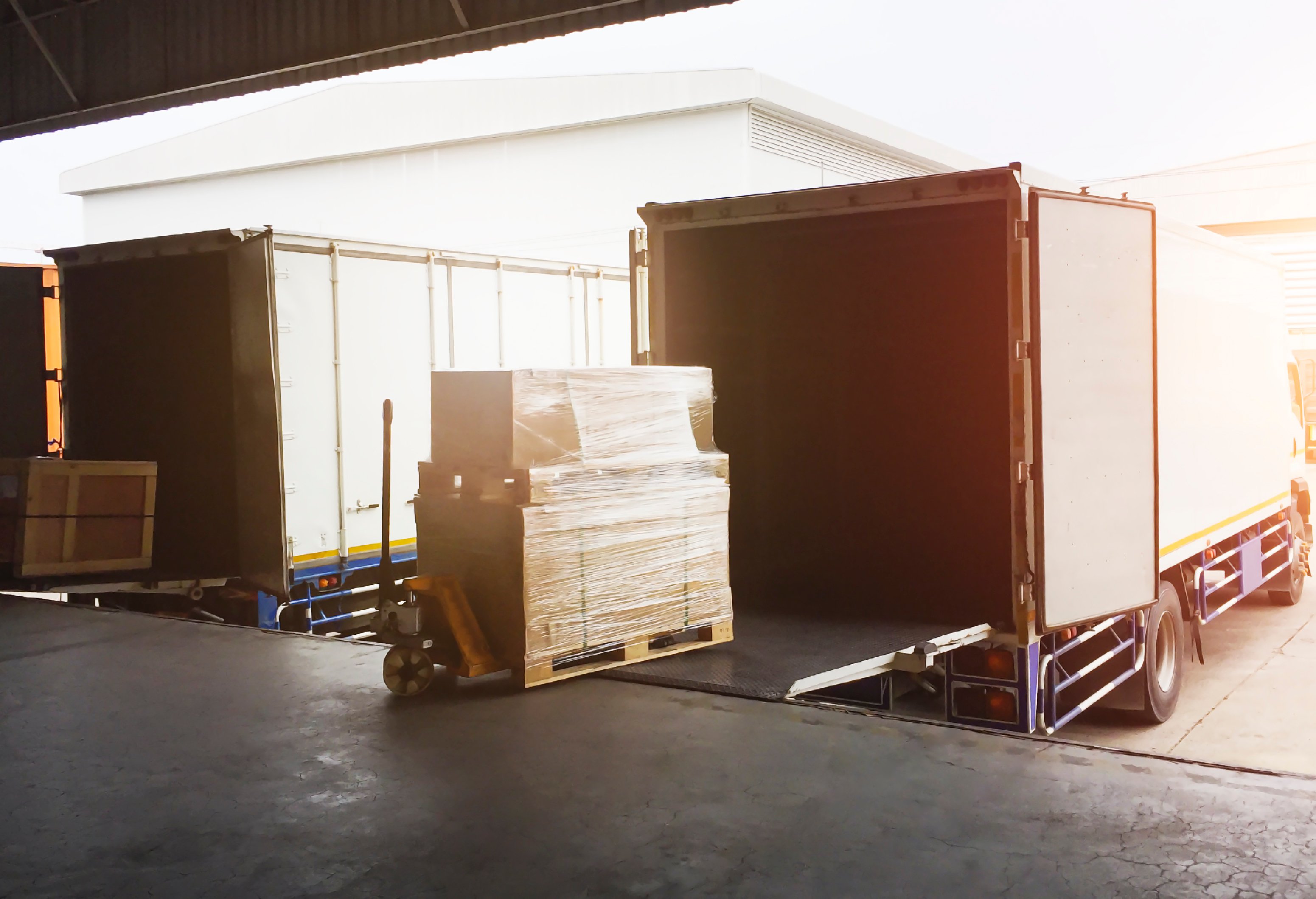 Excess stock being loaded into the back of a truck.