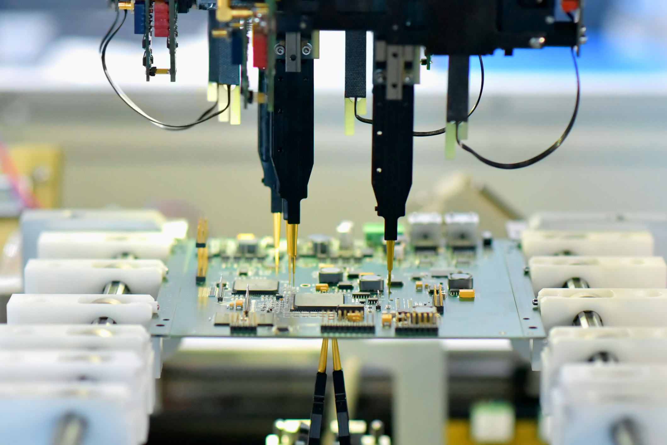 Robot automatically assembles circuit board with electronic components in a modern factory stock photo.