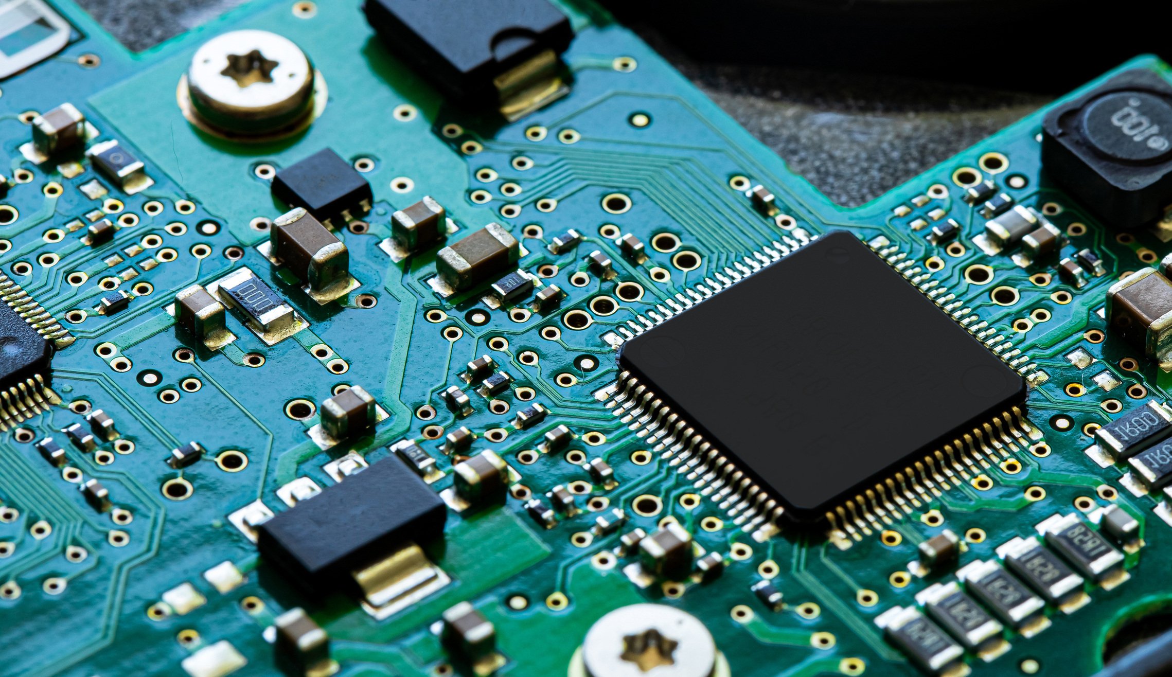 Close up of a PCB board with electronic components on it.