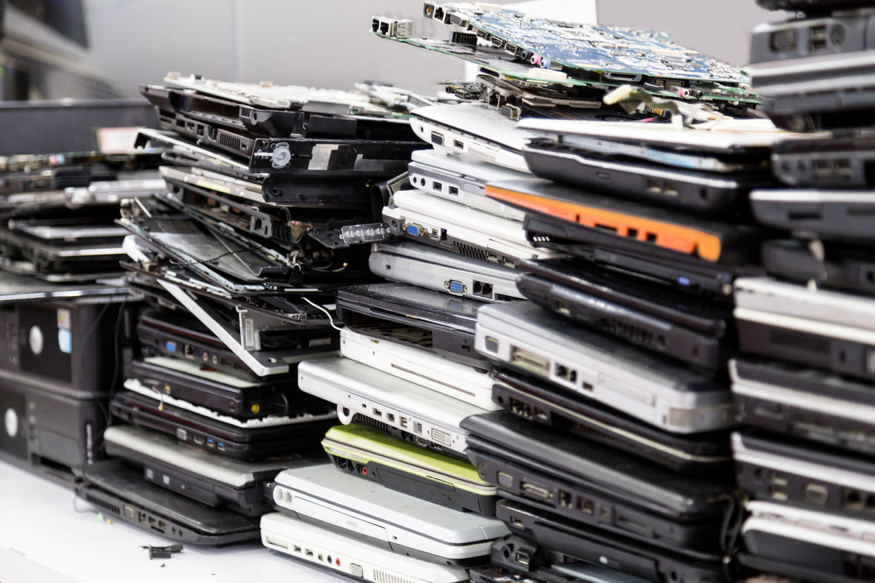 Piles of discarded laptops and other electronic waste.