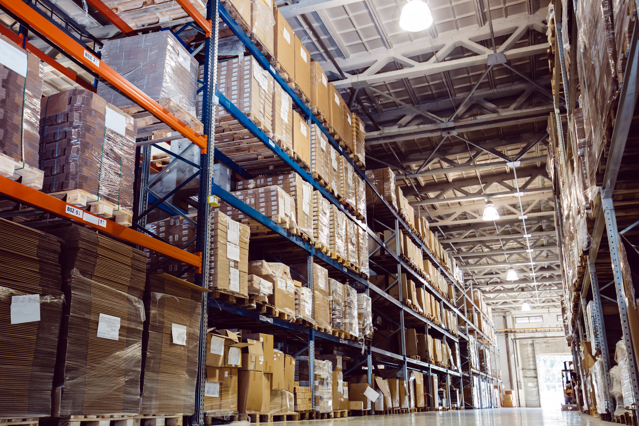 Warehouse storage facility with many boxes on the shelves.