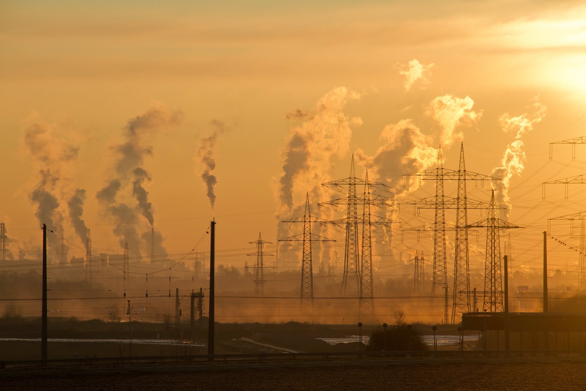 Fumes and pollution being pumped into the atmosphere in an industrial area.