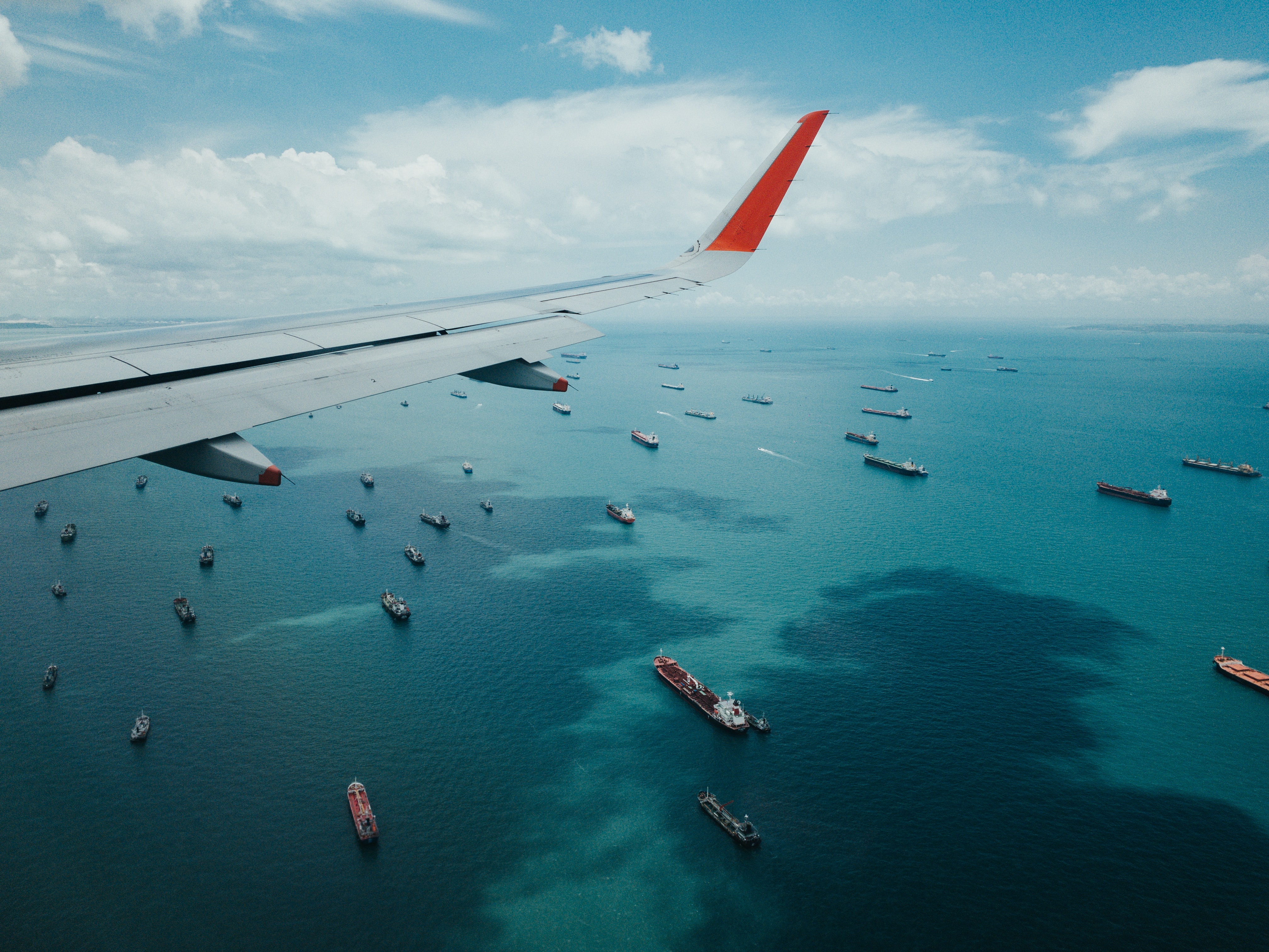 Crowd of shipping container idling in the ocean.